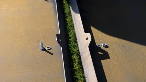 Artificial turf seam detail near concrete surface