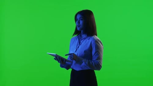 Female Data Center Technician Using Digital Tablet on Chroma Key Background