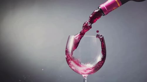 Red Wine Being Poured Into Clear Glass