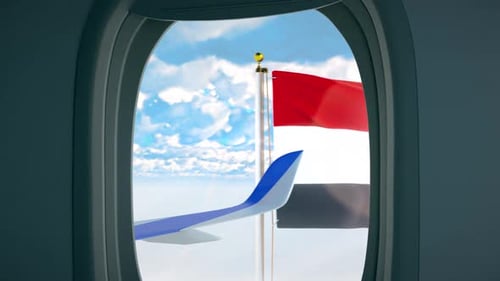 Egyptian Flag Waving Outside Airplane Window in Clouds