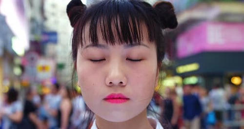 Trendy young asian woman smiling in causeway bay Hong Kong shot on red
