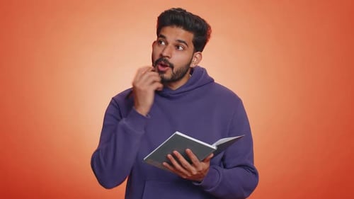 Man Writing in Notebook Gets an Idea