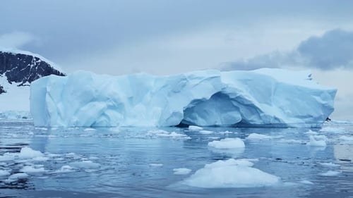 A Massive Arctic Iceberg Floating Through Calm Polar Glacial Waters