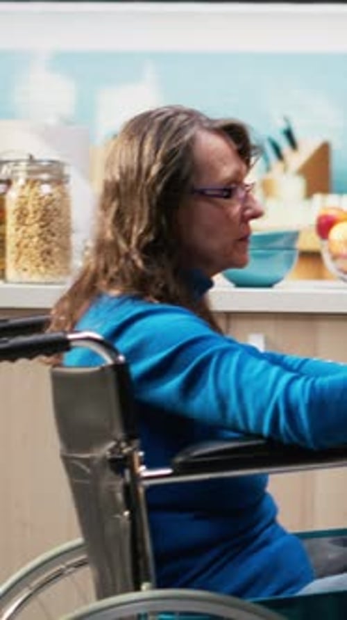 Vertical Video Aged Woman with Chronic Impairment Serves Coffee with Husband