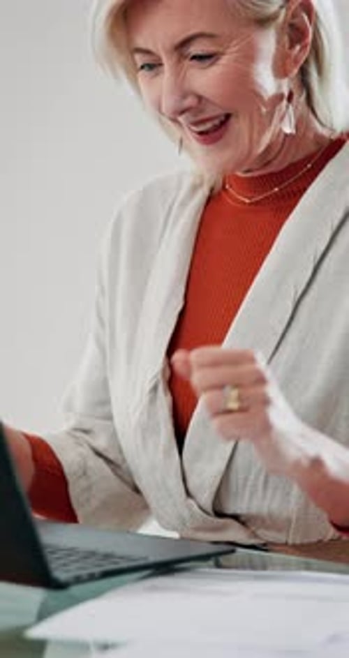 Senior woman, laptop and celebrate success in home, retirement announcement and excited for 401k