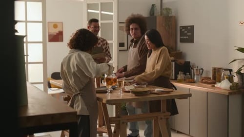 Friends Together Preparing Food in a Sunlit Kitchen