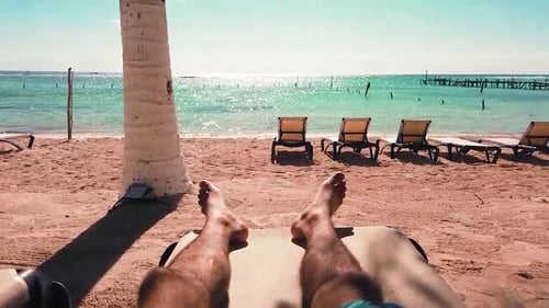 First person pov, man layed on a lounger in the beach in the Riviera Maya, Quinanta Roo, Mexico