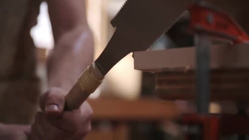 Carpenter uses pull saw to cut wood in calgary alberta Canada