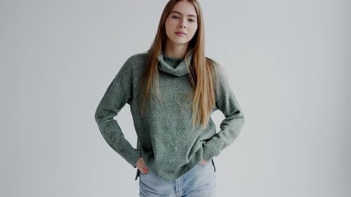 Confident Attractive Woman Model in Trendy Sweater and Jeans Posing on Camera