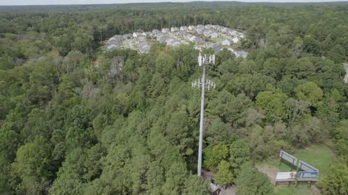 Antenna in front of neighborhood, communications.