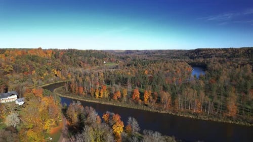 Autumn landscape with vibrant foliage and winding river in the countryside