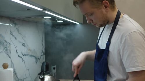Young Adult Cooking Indoors in Kitchen