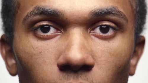 Man Eyes Open Close Up in Slow Motion on White Background