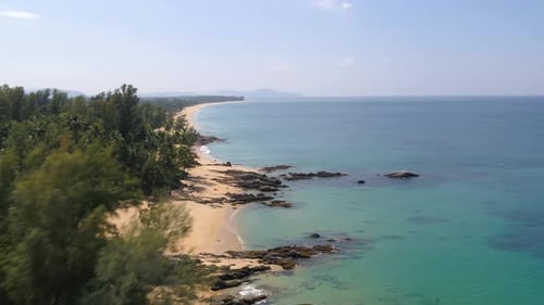 Flying Over The Beautiful Turquoise Blue Water In Natai Beach With Lush Green Trees On The Sandy Sho