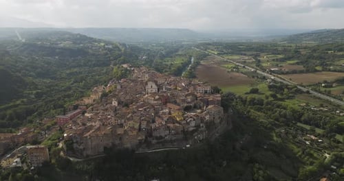 Aerial view of medieval town and hills, Italy.