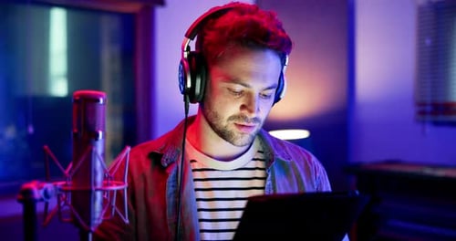 Man, musician and headphones with tablet in studio for music production