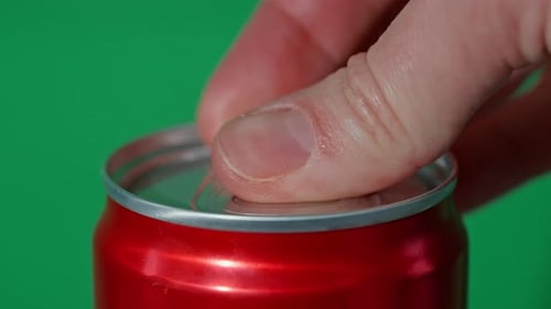 Opening of Red Soda Can on Green Background
