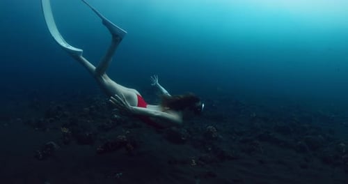 Beautiful Woman Freediver Glides Underwater in Blue Ocean Sexy Woman Swims in Deep Sea