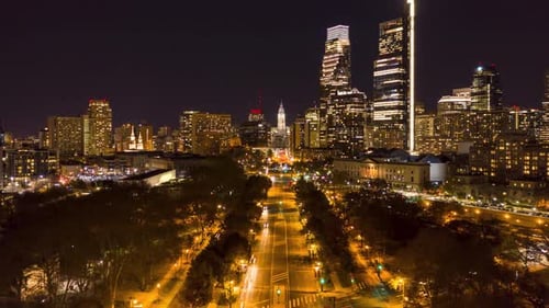 Aerial Timelapse Night Cityscape and Skyline Revealing Parkway with Moving Cars and Building Lights