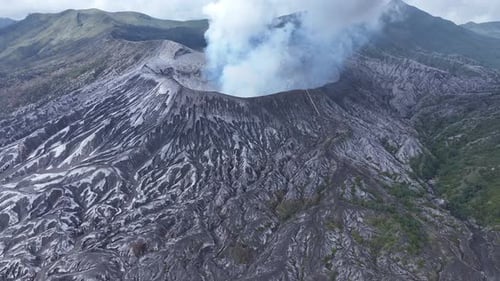 aerial view flying to mount Bromo active volcano above sea of clouds, Java, Indonesia