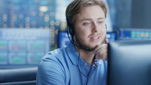 In the Customer Support Center Representative Makes Calls and Talks with Customer Through the Heads