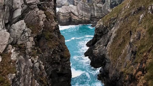 Drone Flying Through Island Cliffs in Ireland Aerial View Near of Mizen Head
