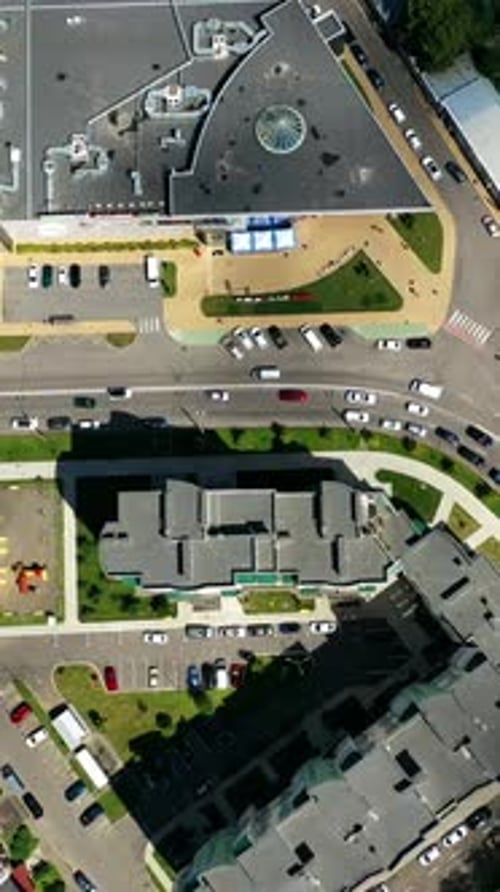 Modern cityscape. Residential streets and cars between apartment building rooftops.