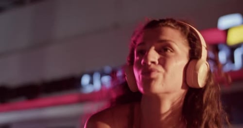 Young Woman Dancing on Street at Night