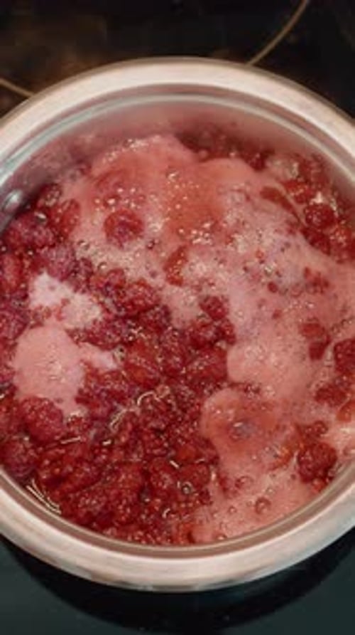 Red Raspberry Jam Bubbling in Pot at Home