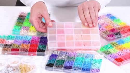 Hands Sort Through Wide Selection of Colorful Crafting Beads