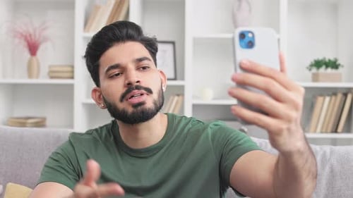 Man Using Smartphone for Video Call Indoors