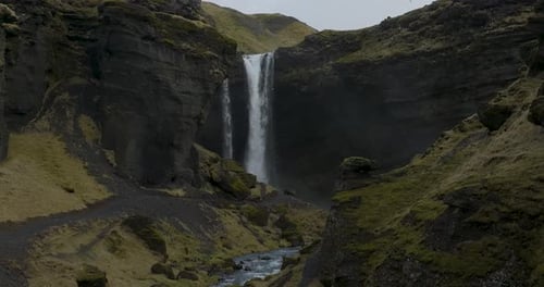 Kvernufoss Waterfall in Beautiful Cave with Scenic Cliffs in Iceland