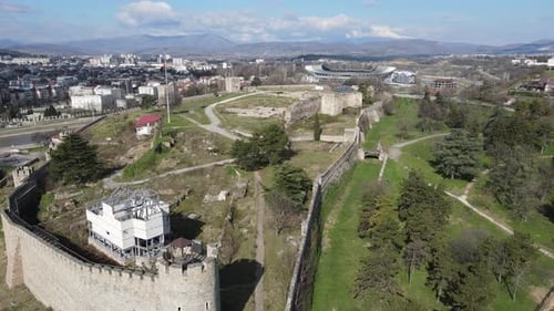 The castle in the center of Skopje is among the buildings, flag waving in the castle garden