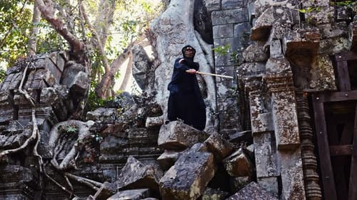Masked Man Wielding A Sword At Temple