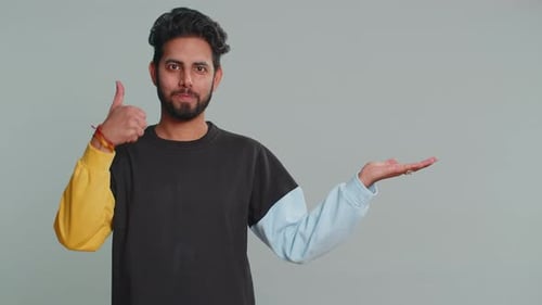Indian Man Showing Thumbs Up Pointing Empty Place Advertising Area for Commercial Text Copy Space