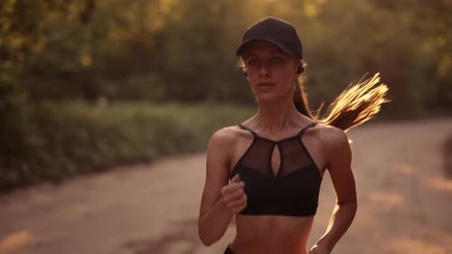 Woman Runs Toward Camera on Dirt Path