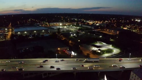Traffic on the freeway in the city of Grand Rapids, Michigan being revealed by a drone in the mornin