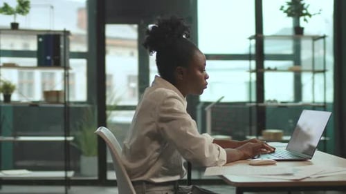 Beautiful Young African American Business Woman Sitting on Chair Use Laptop Working in Office Look