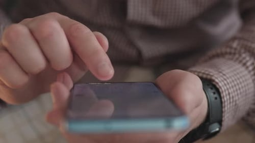 A Closeup View of Hands Skillfully Using a Touchscreen Smartphone in an Effective Manner