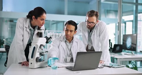 Scientists Collaborating on Research in a Modern Lab