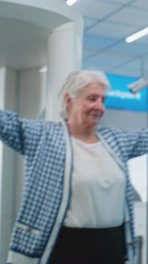 Security Checkpoint in Airport Female Security Officer Inspects Elderly Woman for Plane Flight