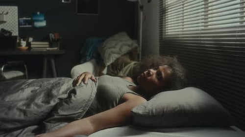 Sleepless Girl Lying in Bed at Night