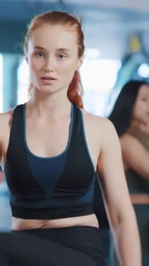 Dedicated and Focused Young Woman Engaging in Intense Fitness Training at the Gym