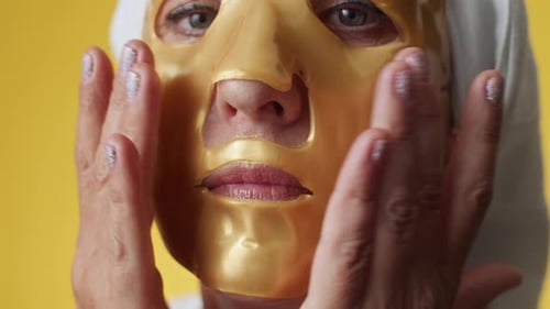 Mature Woman Smoothing Sheet Hydrating Mask on Face