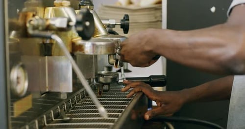 4k video footage of aun unrecognizable barista making a coffee at a cafe