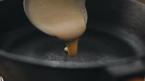 Pancake Batter Poured into a Cast Iron Skillet