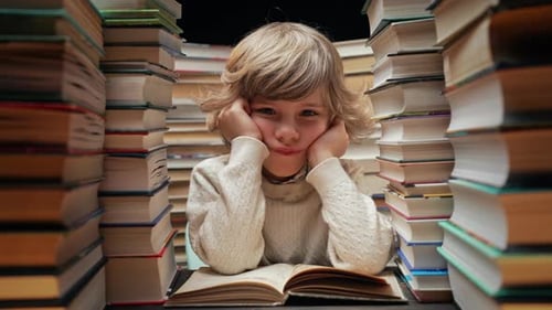 Bored Little Schooler Boy Sighs While Sitting at Classroom or Library Desk Sad Tired Kid Doesnt Want