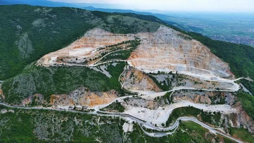 Natural Quarry is Located Near Road Against Backdrop of Rhodope Mountains and Hills with Forests and