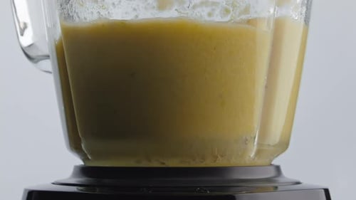 Vitamin Fruit Shake Mixing Inside Blender Bowl in Super Slow Motion Close Up