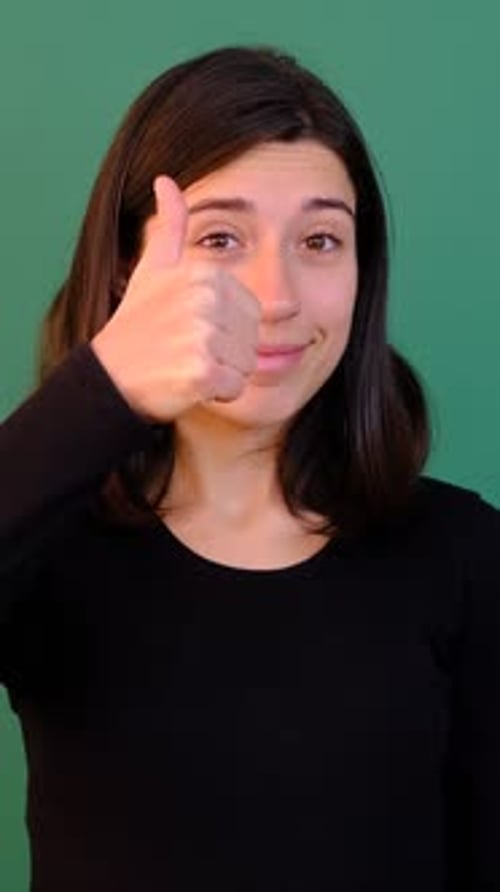 Young Woman Gives Thumbs Up on Green Screen